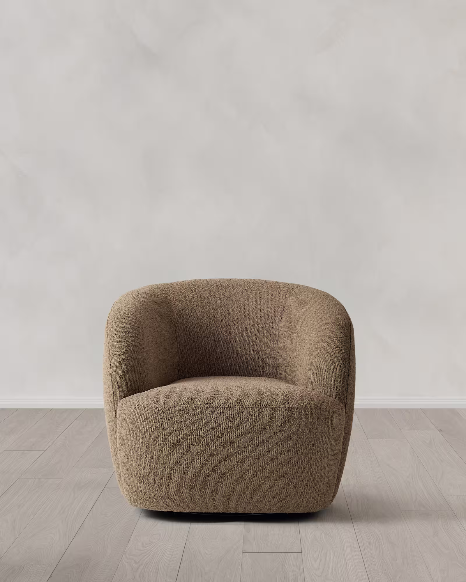 Armchair on a light wooden floor with a beige fabric.