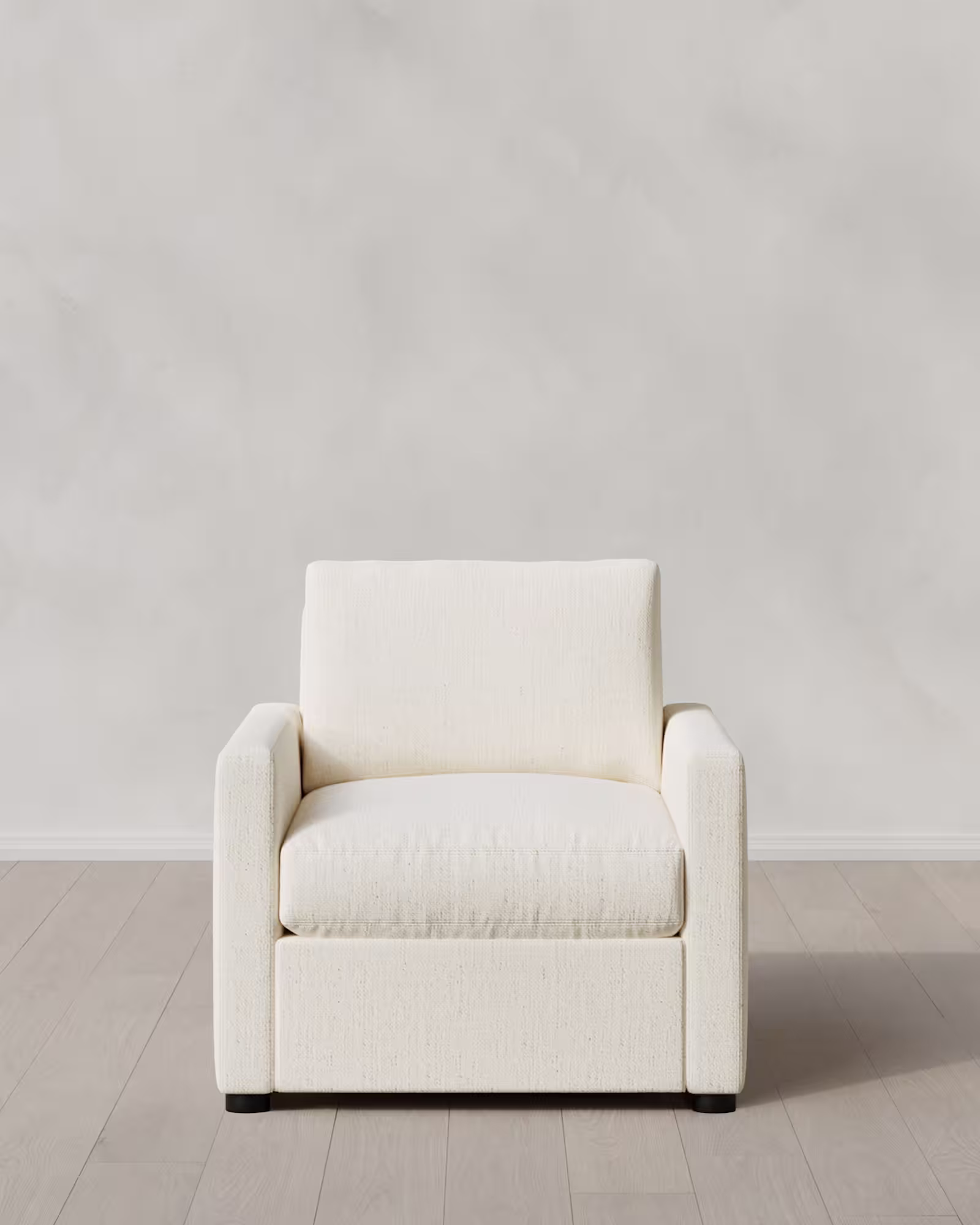 Accent chair on a light floor with neutral upholstery.