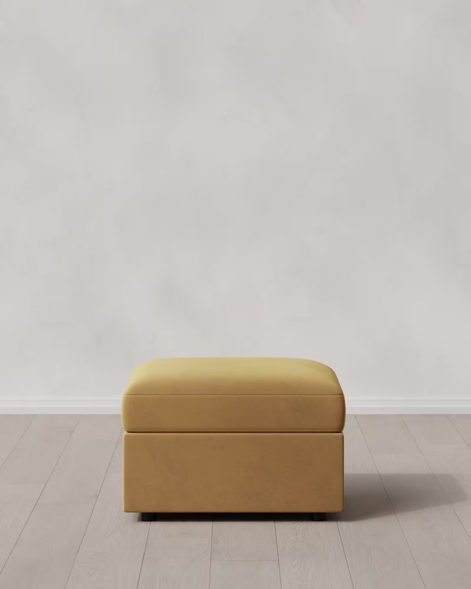 Caramel colored ottoman on a light floor.